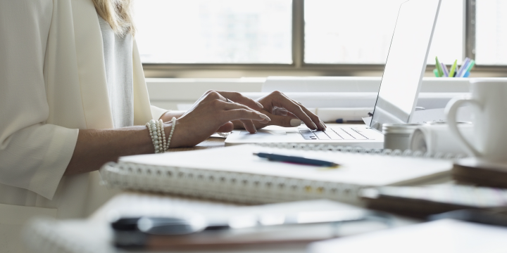 Dressy females hands on keyboard in office